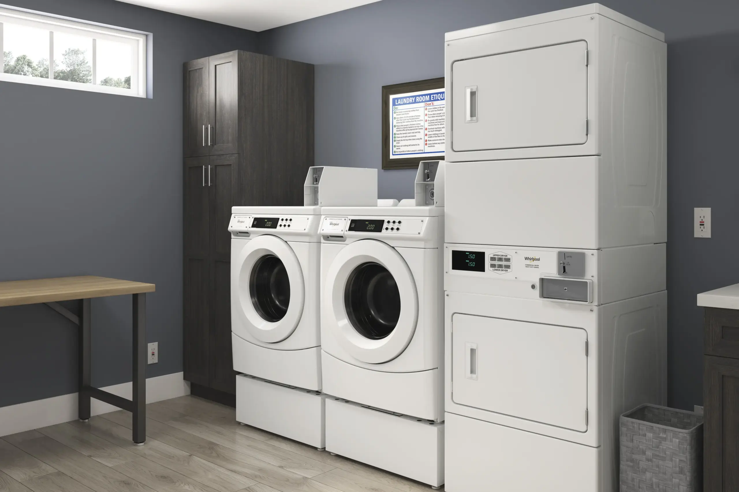 Laundry room with two front-loading washing machines and a stacked dryer, dark wood cabinet, and a framed laundry etiquette poster on a blue wall.